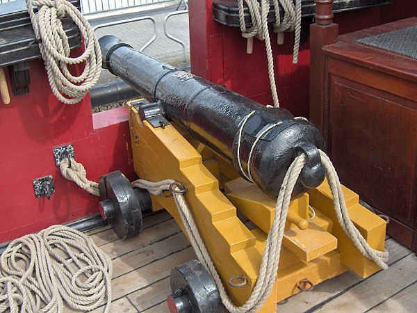 An early naval cannon, which is allowed to roll backwards slightly when fired, and therefore must be tethered with strong ropes