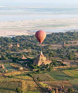 A hot-air balloon flying over one of the many pagodas in Bagan, Myanmar