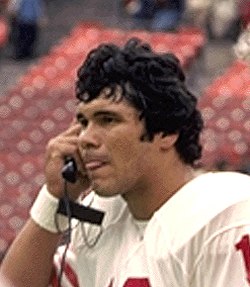 A picture of Jim Plunkett on a phone.