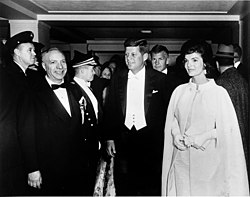 President John F. Kennedy and First Lady Jacqueline Kennedy, wearing a gown designed by Ethel Franken of Bergdorf Goodman, arrive at inaugural ball on the evening of Inauguration Day. John F. Kennedy Inaugural Ball, 20 January 1961.jpg