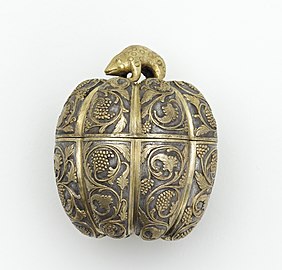 Lidded box in the form of a melon with grapevines and knob in the shape of a rodent. Cast and hammered silver with chased and ring-punched decoration and leaf gilding. Tang dynasty, late 7th-early 8th century