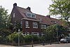 Complex van zeven aaneengesloten woonhuizen