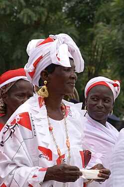 Women with knotted headscarves presenting their village at the public parade to mark Mali's 50th Independence Day in Kayes