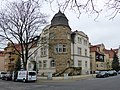 Tenement house with pillars from the old enclosure, in a corner