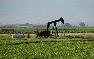 Gas-powered oil well within the Mountain View field, surrounded by row crops MountainViewWell.jpg