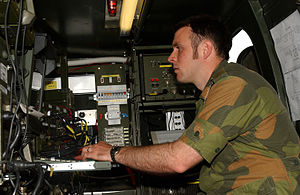 Norwegian signals captain seated w switching gear.jpg
