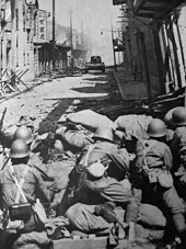 Japanese Special Naval Landing Forces defending against a Chinese Vickers 6-ton tank during the Battle of Shanghai, 1937.