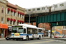 A 2003 Orion VII OG CNG (7593) on the Queens Plaza-bound B61 in Long Island City in 2007, prior to the creation of the current service plan Nyctbus-nyctsubway.jpg