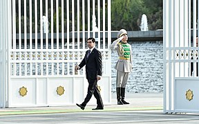 Gurbanguly Berdimuhamedow walking outside the Oguzkhan Presidential Palace and onto the square.