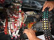 A heavily decorated dashboard in a Mumbai taxi. Note the left-handed column shift for the manual transmission.