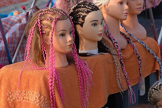 Puppet heads with colored braided hair, Scheveningen, Netherlands