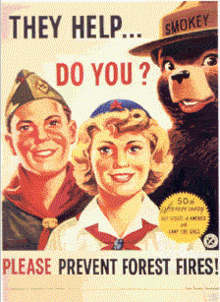 Smokey Bear with members of the Boy Scouts of America and the Camp Fire Girls celebrating the 50th anniversary of their founding. Smokey with scouts.png