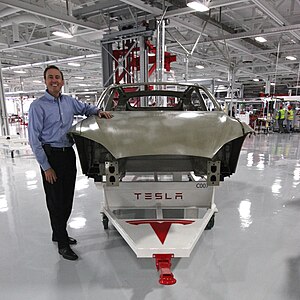 The Model S body in white after completing body assembly at the body centre. Also pictured is Steve Jurvetson, board member of Tesla Motors and the owner of the first Model S produced.