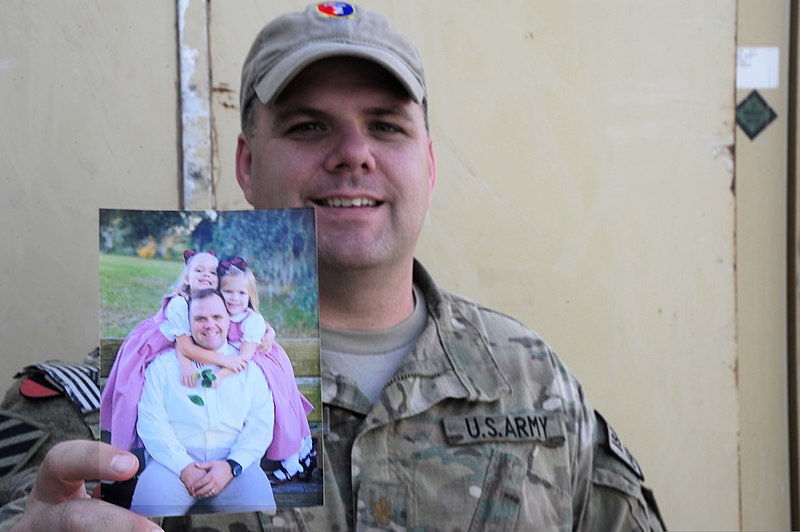 File:U.S. Army Maj. Bill Meredith, a brigade operations officer with the 2nd Combat Brigade Team, 3rd Infantry Division, serving with Combined Team Uruzgan in support of Operation Enduring Freedom, holds up a photo 130611-A-FS372-056.jpg