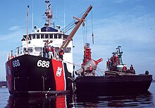 Red Cedar swapping tall summer buoys with sleek Ice-resistant winter buoys in the Potomac River USCGC Red Cedar placing ice buoys.jpg