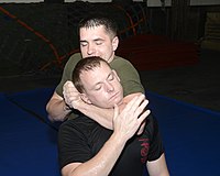 Submissions are often indicated in grappling by tapping the opponent with the hand, or verbally submitting to the opponent or official. USS Mesa Verde (LPD 19) 140804-N-HB951-014 (14943753691).jpg