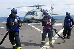 Flight deck crew of RSS Tenacious perform refuels the helicopter Lonewolf 50 of Helicopter Antisubmarine Squadron Light 45 on 26 June 2008.