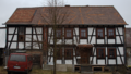 English: Half-timbered building in Helpershain, Im Hof 12, Ulrichstein, Hesse, Germany This is a picture of the Hessian Kulturdenkmal (cultural monument) with the ID Unknown? (Wikidata)