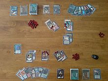 A top-down view of a two-player game of Vampire: The Eternal Struggle, with cards laid out on a table.
