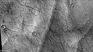 Close up of eskers in Lau Crater, as seen by CTX camera (on Mars Reconnaissance Orbiter). The dark lines are dust devil tracks. Note: this is an enlargement of the previous image of Lau Crater.
