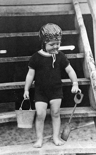 File:Young child in swimming costume with bucket and spade (6508793461).jpg