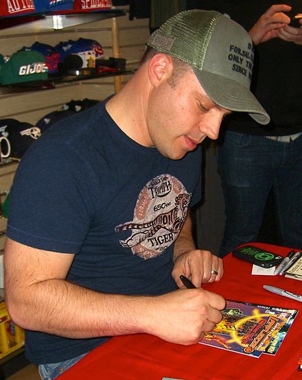 Writer Geoff Johns signing a copy of Green Lantern: Larfleeze Christmas Special at Midtown Comics in Manhattan.