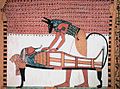 Image 45Anubis was the ancient Egyptian god associated with mummification and burial rituals; here, he attends to a mummy. (from Ancient Egypt)