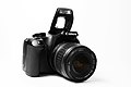 Canon EOS 1000D z objektivom Canon EF-S 18-55mm f/3.5-5.6 II in izkočeno bliskavico