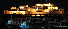 Castle Cornet seen at night over the harbour of St Peter Port. Castle Cornet Floodlit.jpg