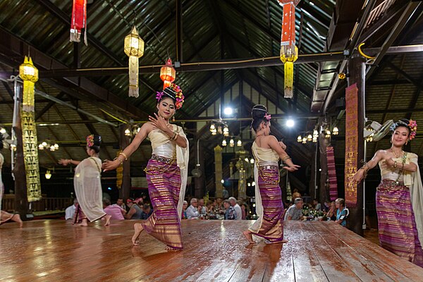 Dancers in traditional costumes perform a courtship dance.