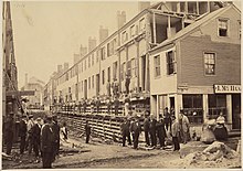 Houses on north side of Fayette Street, west of Church Street, being raised in 1868. Church St District Boston Fayette St Facing West, North Side, Being Raised 1868.jpg