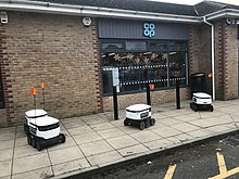 Delivery robots outside of a co-op store Co-op delivery robots (50749382358).jpg