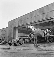 An RAF Douglas Dakota is towed out of a hangar at RAF Lubeck, after maintenance in April 1949 during the Berlin airlift