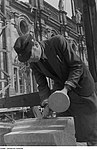 A left-handed stonemason with mallet and chisel