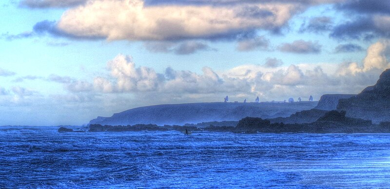 File:GCHQ Bude, seen from Widemouth Bay, with surfer in foreground.jpg