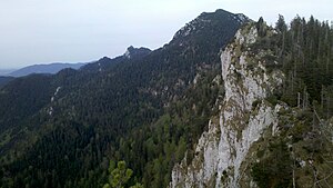 View over the ridge of the glass wall, in the background the Benediktenwand