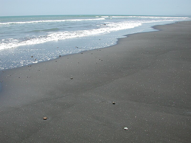 File:Glistening black sand beach at White Cliffs.jpg