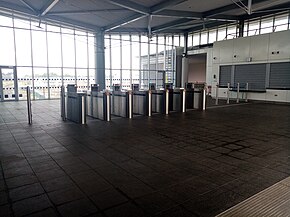 The stations interior, featuring a row of ticket gates and an unstaffed ticket office. Hansfield station interior.jpg