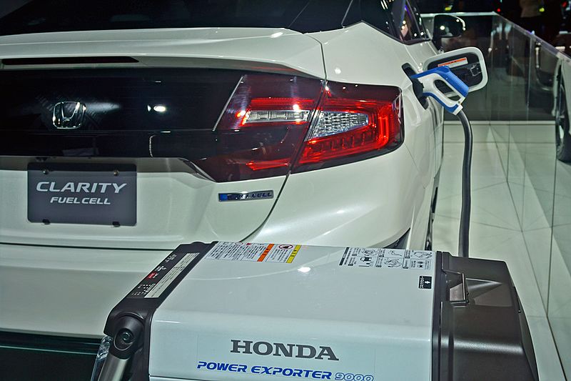 A Honda Clarity fuel cell car charging at a fuel cell recharge station.