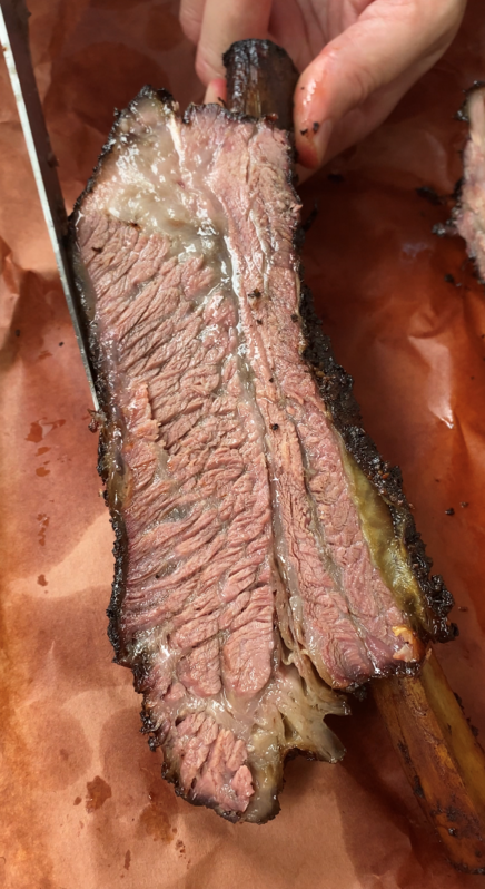 Inside of a beef rib cooked on a smoker grill