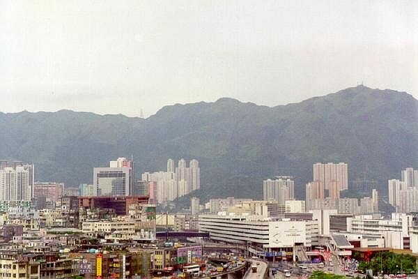 The airport was surrounded by high-rise buildings. The airport car park is at the centre, and offices are on the right of the photograph.