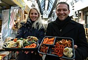 Two people with food purchased at the market (2014)