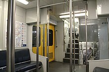 Goninan trailer car vestibule with stairs leading to upper & lower decks after refurbishment L, R & S Set interior vestibule stairs, hand rails and doors.jpg