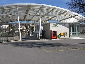 Open-air station with curved metal-and-glass roof