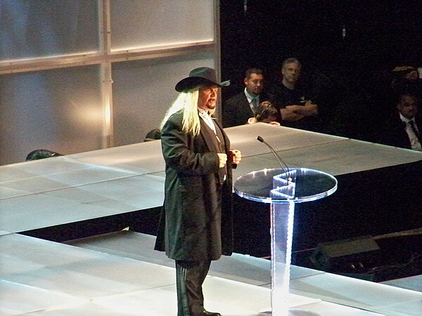 Hayes speaking at a WWE Hall of Fame ceremony in 2009