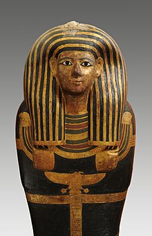 Gilded and painted mummy-shaped coffin lid with inlaid eyes