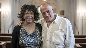 Rita Dove and Eduardo Montes-Bradley in the Temple House of Israel sanctuary for the filming of Rita Dove: An American Poet Montes-Bradley and Rita Dove.jpg