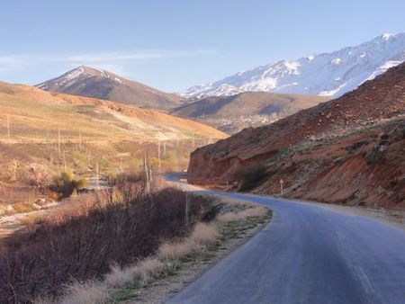 The white snowy mount is Dena Mount (Pazan Pir Peak), black pyramidal shape mount is; Kuh e Noqol, small mount lies in front of them is; Takht, the khaki hills in the left is Mowrderaz, and the river under the roud is: Rudkhaneh ye Sard (Cold River). This photo shows Noqol's scenery in December 2013.