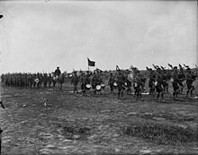 PPCLI parading with the pipes and drums at its head, July 1917. Princess Patricia's Canadian Light Infantry parade with regimental colour, July 1917 - MIKAN 3397740.jpg