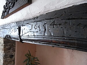 Lintel over fireplace of Old Kitchen, Simonsbath House, into which is carved the date "1654", taken to have been carved by James Boevey on completion of the building of the house SimonsbathHouseFireplaceLintelDated1654.jpg